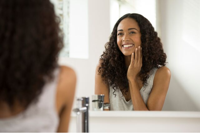 woman-looking-in-the-mirror-after-applying-face-moisturizer woman-looking-in-the-mirror-after-applying-face-moisturizer